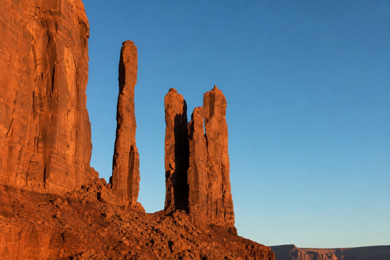 The Totem Pole rock spires in Monument Valley catching warm side light