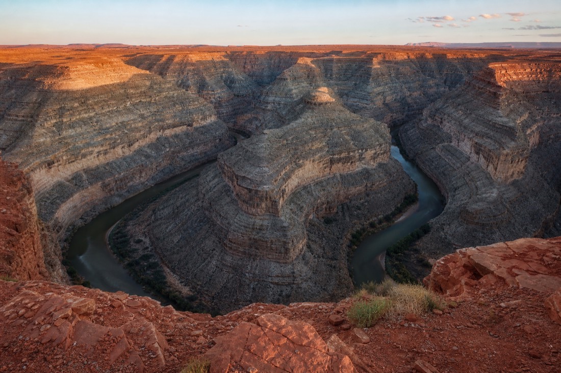 A deep river canyon making tight looping meanders through gray-and-tan rock, seen from a high overlook