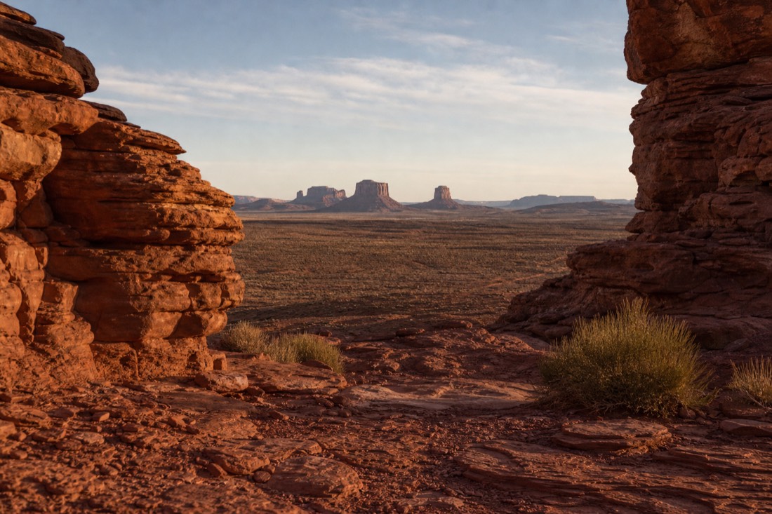 The Mittens framed by the wide entrance view over Navajo tribal park land